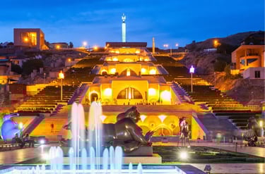 Illuminated Cascade Complex in Yerevan Armenia at night with fountains and statues.