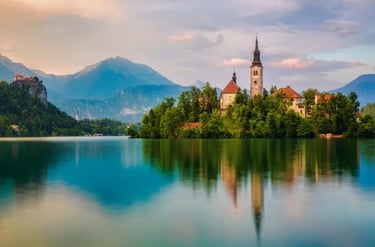 Scenic view of Lake Bled island with the Assumption of Mary Church and Julian Alps mountains in Slovenia.