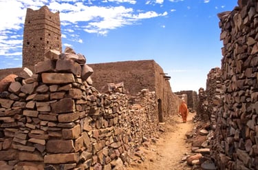 Ancient stone architecture and narrow alleyway in the historic desert town of Chinguetti, Mauritania.