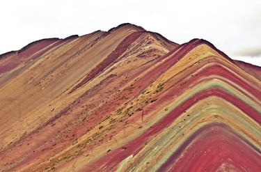 The vibrant mineral layers of Vinicunca Rainbow Mountain in the Andes of Peru.