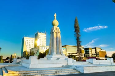 The Monument to the Savior of the World in San Salvador, El Salvador, under a clear blue sky.