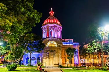 The National Pantheon of Heroes in Asuncion, Paraguay, illuminated with vibrant colors at night.
