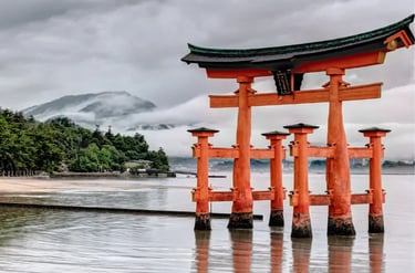 The iconic orange Great Torri Gate of Itsukushima Shrine in Miyajima, Japan, on a misty day.