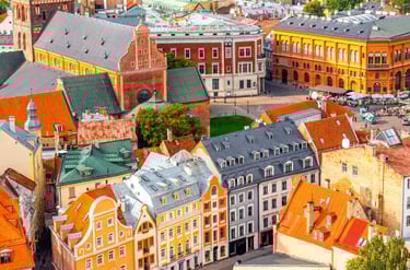 Aerial view of colorful historical buildings and red-tiled roofs in Riga Old Town, Latvia.
