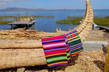 Traditional Peruvian reed boat with colorful woven textiles on Lake Titicaca.