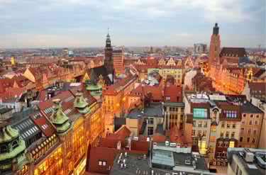 Panoramic aerial view of Wroclaw Old Town at dusk featuring historic red roof architecture in Poland.