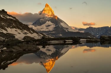 Sunset glowing on the Matterhorn peak reflected in Stellisee lake in the Swiss Alps.