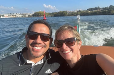 Couple enjoying a private Douro River cruise aboard a vintage wooden speedboat in Porto