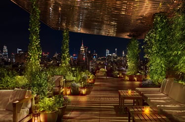 The Roof at The Public Hotel – Lush rooftop lounge with stunning NYC skyline views.