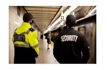 two security officers standing in a subway station