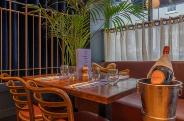 a restaurant table with a bottle of champagne and a bottle of champagne