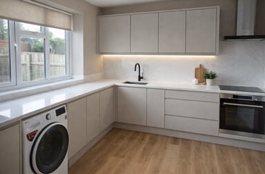 Modern kitchen renovation with white cabinets and integrated appliances in Brighton home.