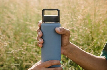Two friends sharing a reusable water bottle