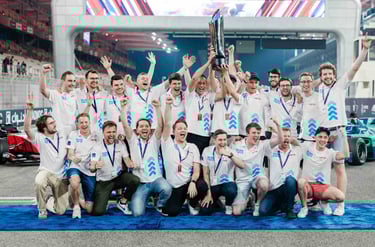a group of people standing around a trophy