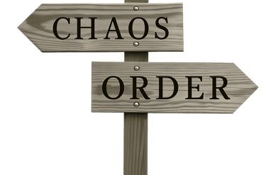 Rustic wooden signpost with arrows pointing to Chaos and Order