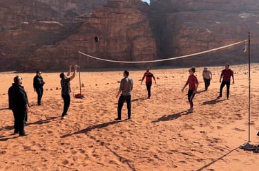 a group of people playing volleyball in the desert