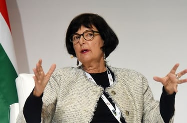 a woman in a white jacket and glasses