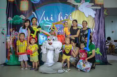 a group of people posing for a photo with a bunny on the ground