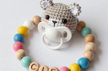 Artisan hands weaving colorful threads into a small decorative item.