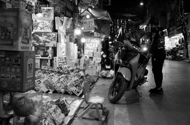 black and white night photography Hanoi light shadow street scene Vietnam