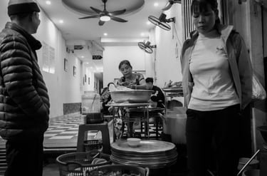 black and white night photography Hanoi light shadow street scene Vietnam