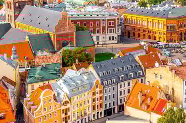 Aerial view of colorful historical buildings and red-tiled roofs in Riga Old Town, Latvia.