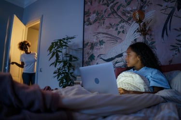 A single mother working on a side hustle while kids sleep.