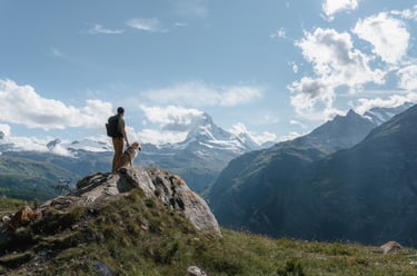 a person standing on a mountain top with a backpack