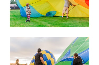 Ground crew and spectators preparing colorful hot air balloons for flight at an outdoor festival.