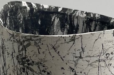 a white vase with black underglaze textural pattern