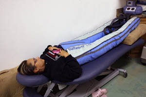 a woman laying on table wearing compression pants