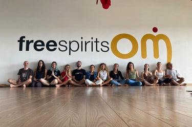 a group of yogis sitting on a wooden floor