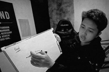 The owner of Guanzon Media writing on a white board