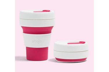 a cup of coffee with a pink cupcake on top of it