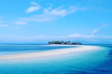 a small island with a small island in the middle of the ocean of Pink Beach
