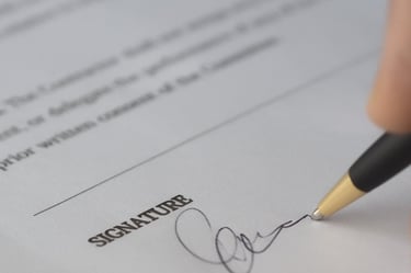 Person signing an application document, highlighting Admit 360's meticulous application review
