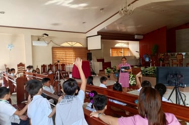 Elementary student raising his hand in a school chapel