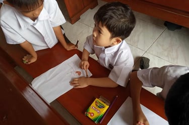 Elementary students coloring with crayons