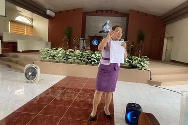 Teacher with a mic talking in front 
