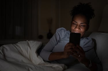 Woman privately messaging on her phone at night representing confidential WhatsApp support
