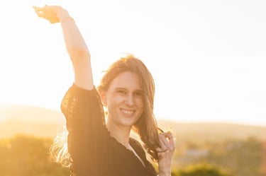 a woman in a black dress holding a kite