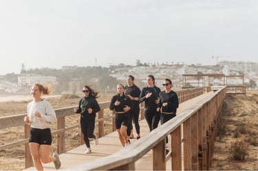 a group of people running on a boardwalk