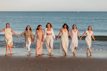 a group of women in white dresses holding hands and holding hands