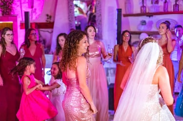 a bride and groomsmid dancing at a wedding