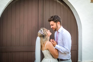 a bride and groom standing in front of a wooden door