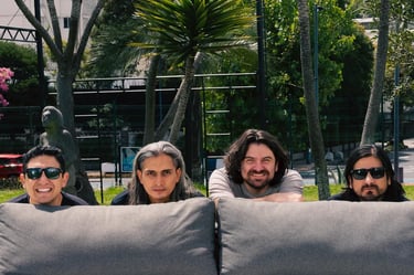 a group of four people sitting behind on a couch