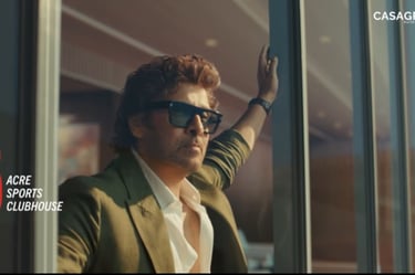 Actor Chiyaan Vikram looking out from a luxury balcony for a Casagrand real estate advertisement.