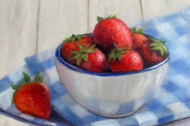 An original oil painting of strawberries in a bowl on a blue & white tablecloth