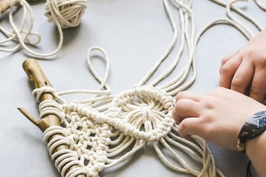 Artesano elaborando nudos complejos para joyería de macramé.