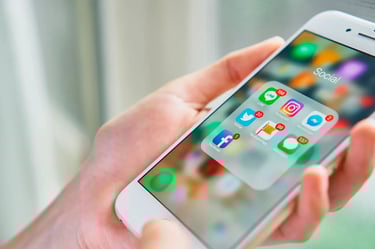 a person holding a cell phone with a cell phone in their hand